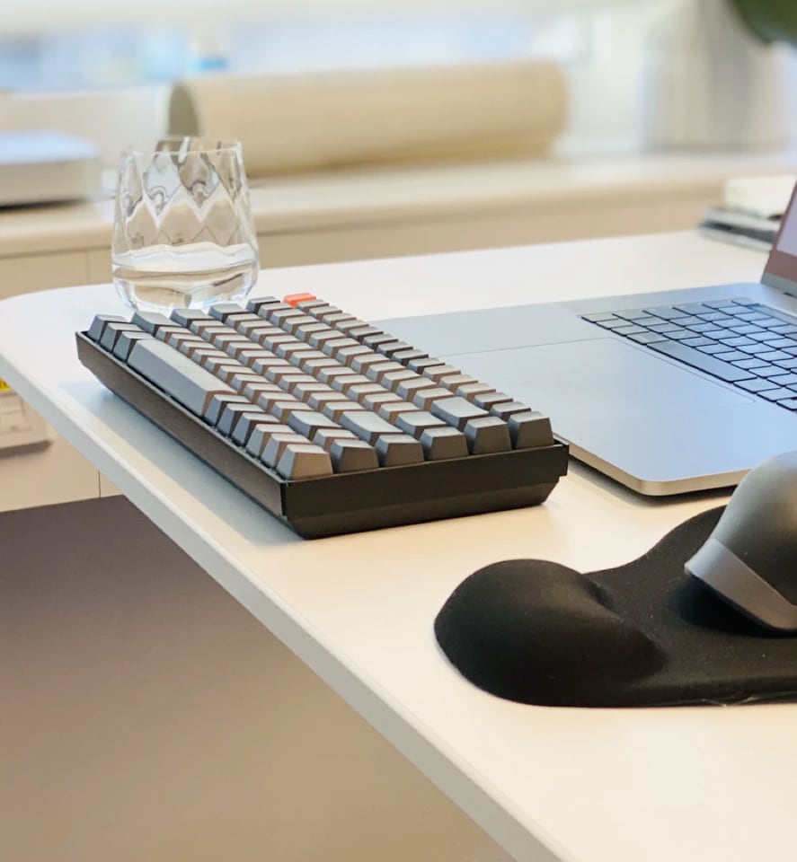 glass and keyboard on a desk